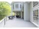 The spacious outdoor deck features a covered area with a ceiling fan, grill and dining set at 1253 Rivermark Ct, Lawrenceville, GA 30043