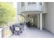 Enjoy outdoor dining on the covered deck with a ceiling fan, grill, and a view of the lush greenery at 1253 Rivermark Ct, Lawrenceville, GA 30043