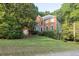 This home features a well manicured lawn, brick facade, and bay window at 1253 Rivermark Ct, Lawrenceville, GA 30043