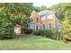 Charming two-story brick home featuring well-maintained landscaping and a welcoming front entrance at 1253 Rivermark Ct, Lawrenceville, GA 30043