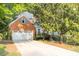 Traditional brick home featuring a two-car garage and well manicured lawn at 1253 Rivermark Ct, Lawrenceville, GA 30043