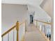 Bright upstairs hallway with wooden railings and a view of the living room below at 1253 Rivermark Ct, Lawrenceville, GA 30043