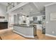 Modern kitchen with white cabinets, stainless steel appliances, granite countertops, and an eat-in kitchen island at 1253 Rivermark Ct, Lawrenceville, GA 30043