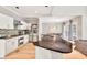 Well-equipped kitchen featuring granite counters, stainless steel appliances, an island, and access to dining and living areas at 1253 Rivermark Ct, Lawrenceville, GA 30043