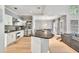 Kitchen featuring granite countertops, stainless steel appliances, ample cabinet space, and open access to the dining area at 1253 Rivermark Ct, Lawrenceville, GA 30043