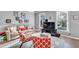 Bright living room featuring hardwood floors, neutral walls, and large windows at 1253 Rivermark Ct, Lawrenceville, GA 30043