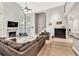 Open-concept living room with soaring ceilings, fireplace, large sofa, and staircase leading to a second floor landing at 1253 Rivermark Ct, Lawrenceville, GA 30043