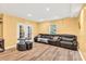 Cozy living room with recessed lights, french doors, and a comfortable leather sofa at 1253 Rivermark Ct, Lawrenceville, GA 30043