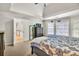Spacious bedroom with a dresser, two windows with blinds, and ensuite access at 1253 Rivermark Ct, Lawrenceville, GA 30043