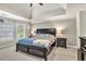 Main bedroom features a tray ceiling, ceiling fan and two windows at 1253 Rivermark Ct, Lawrenceville, GA 30043