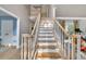 Elegant staircase with white risers and light wood treads, leading to the upper level at 1253 Rivermark Ct, Lawrenceville, GA 30043