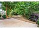 The backyard features mature trees and a concrete patio at 186 Wallnut Hall Cir, Woodstock, GA 30189