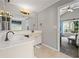 Bright bathroom features a large mirror, neutral walls, and updated fixtures at 186 Wallnut Hall Cir, Woodstock, GA 30189