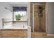 The bathroom features a jetted tub and a tiled shower with glass doors at 186 Wallnut Hall Cir, Woodstock, GA 30189