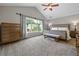 Spacious bedroom with neutral carpet, vaulted ceilings, a ceiling fan and bright natural light at 186 Wallnut Hall Cir, Woodstock, GA 30189