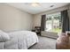 Cozy bedroom features natural light and neutral colors at 186 Wallnut Hall Cir, Woodstock, GA 30189