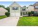 Charming two-story home with a well-manicured lawn, a two-car garage, and a welcoming front porch at 186 Wallnut Hall Cir, Woodstock, GA 30189