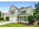 Charming two-story home with a well-manicured lawn, a two-car garage, and a welcoming front porch at 186 Wallnut Hall Cir, Woodstock, GA 30189