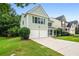 Charming two-story home with a two-car garage, green siding, and well-maintained lawn at 186 Wallnut Hall Cir, Woodstock, GA 30189