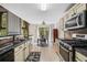 Modern kitchen features stainless steel appliances, granite countertops, and adjacent breakfast nook at 186 Wallnut Hall Cir, Woodstock, GA 30189