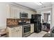 Bright kitchen boasts granite countertops, stainless steel appliances, and ample cabinet space at 186 Wallnut Hall Cir, Woodstock, GA 30189