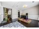 Inviting office with hardwood floors, wainscoting, neutral paint, and a colorful rug at 186 Wallnut Hall Cir, Woodstock, GA 30189