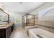 Spacious bathroom featuring a double vanity, soaking tub, and separate tiled shower at 2740 Creekside Manor Dr, Powder Springs, GA 30127