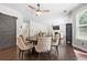 Open dining area with modern furniture, dark floors, barn door and seamless flow to the living room at 2740 Creekside Manor Dr, Powder Springs, GA 30127