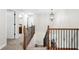Hallway with staircase and wrought iron railings, offering access to the home's bedrooms and bathrooms at 2740 Creekside Manor Dr, Powder Springs, GA 30127