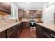 Well-equipped kitchen with granite countertops, stainless steel appliances, and dark wood cabinets at 2740 Creekside Manor Dr, Powder Springs, GA 30127