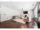 Spacious living room featuring dark floors, a fireplace, neutral decor, and an open layout at 2740 Creekside Manor Dr, Powder Springs, GA 30127