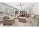Expansive living room with dark hardwood floors, large windows, and an open layout perfect for entertaining at 2740 Creekside Manor Dr, Powder Springs, GA 30127
