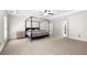 Spacious main bedroom with neutral carpeting, a tray ceiling, a ceiling fan, and ample closet space at 2740 Creekside Manor Dr, Powder Springs, GA 30127