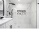 Modern bathroom featuring marble-style tile, sleek black fixtures, and luxury shower system and refined vanity at 904 Fairburn Nw Pl, Atlanta, GA 30331