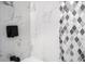 Close up on the shower with marble-look tile with decorative accent at 904 Fairburn Nw Pl, Atlanta, GA 30331