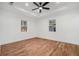 Inviting bedroom featuring warm hardwood floors, a tray ceiling with recessed lighting, and sun-filled windows at 904 Fairburn Nw Pl, Atlanta, GA 30331