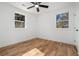 Bright bedroom features hardwood floors, two windows, and a modern ceiling fan at 904 Fairburn Nw Pl, Atlanta, GA 30331