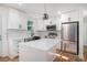 A beautifully designed kitchen with a center island, stainless steel appliances, and sleek white cabinets at 904 Fairburn Nw Pl, Atlanta, GA 30331