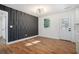 Beautifully designed living room features hardwood floors, stylish modern lighting and a striking accent wall at 904 Fairburn Nw Pl, Atlanta, GA 30331