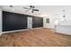 Spacious living room featuring hardwood floors, recessed lighting, and an accent wall open to the kitchen at 904 Fairburn Nw Pl, Atlanta, GA 30331