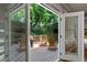 Covered back deck with a view of the trees and outdoor furniture at 1251 Brickton Nw Dr, Atlanta, GA 30318