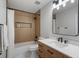 Modern bathroom with a shower/tub combo, wood accent wall, and single vanity at 1251 Brickton Nw Dr, Atlanta, GA 30318