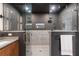 Modern glass enclosed shower with a tiled accent wall next to a stylish sink and vanity at 1251 Brickton Nw Dr, Atlanta, GA 30318