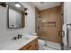 Modern bathroom with a glass shower and wood-like tile, black fixtures, wood vanity and modern mirror and lights at 1251 Brickton Nw Dr, Atlanta, GA 30318