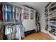 Organized walk-in closet with shelving, hanging rods, and a center dresser at 1251 Brickton Nw Dr, Atlanta, GA 30318