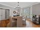 Bright dining room features a modern chandelier, hardwood floors, and large windows for natural light at 1251 Brickton Nw Dr, Atlanta, GA 30318