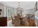 Sunlit dining room with hardwood floors, a modern chandelier, and neutral decor at 1251 Brickton Nw Dr, Atlanta, GA 30318