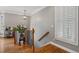 Elegant entryway features hardwood floors, a staircase with iron spindles, and a window with plantation shutters at 1251 Brickton Nw Dr, Atlanta, GA 30318