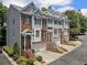 Charming townhomes showcasing a mix of brick and siding, each featuring private garages and inviting front entrances at 1251 Brickton Nw Dr, Atlanta, GA 30318