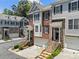Stylish townhomes with brick and siding exteriors, enhanced by well-maintained landscaping and inviting curb appeal at 1251 Brickton Nw Dr, Atlanta, GA 30318